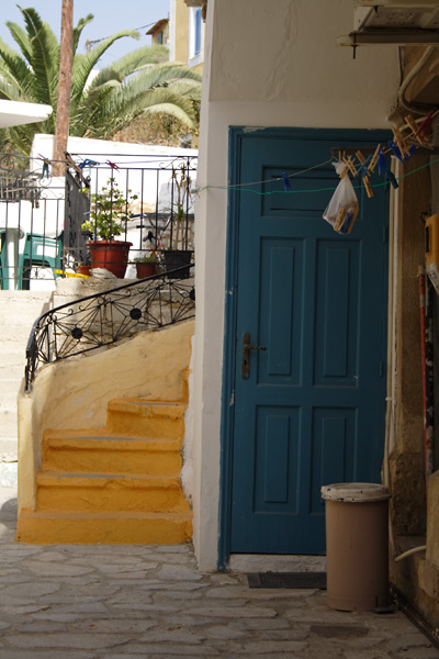 Yellow stairs and blue door in Pothia