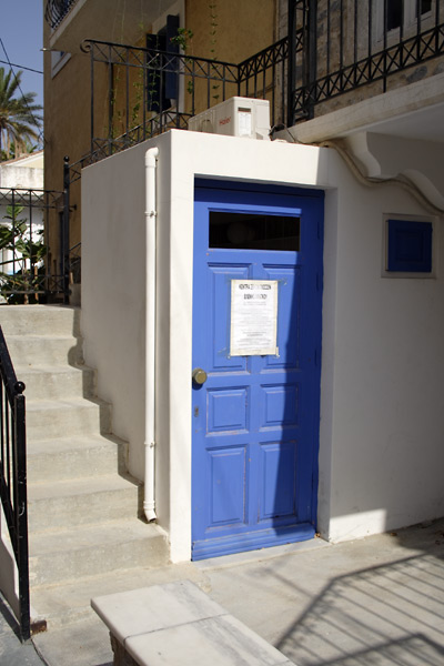 Privy with blue door in Pothia's old town