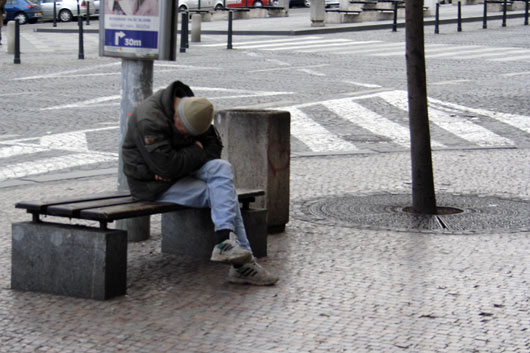 Sleeping man on a bench in Prague